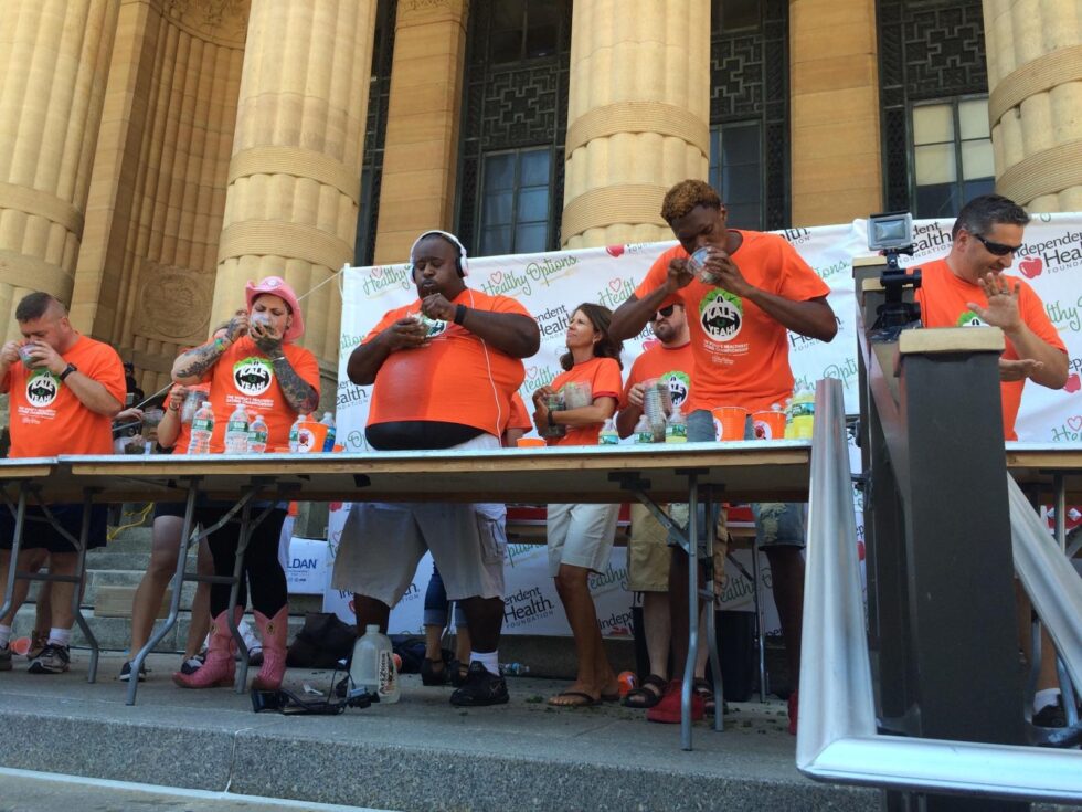 Professional competitive eaters on stage during a live kale-eating contest, photographed as part of an experiential event designed to generate earned media and public engagement.